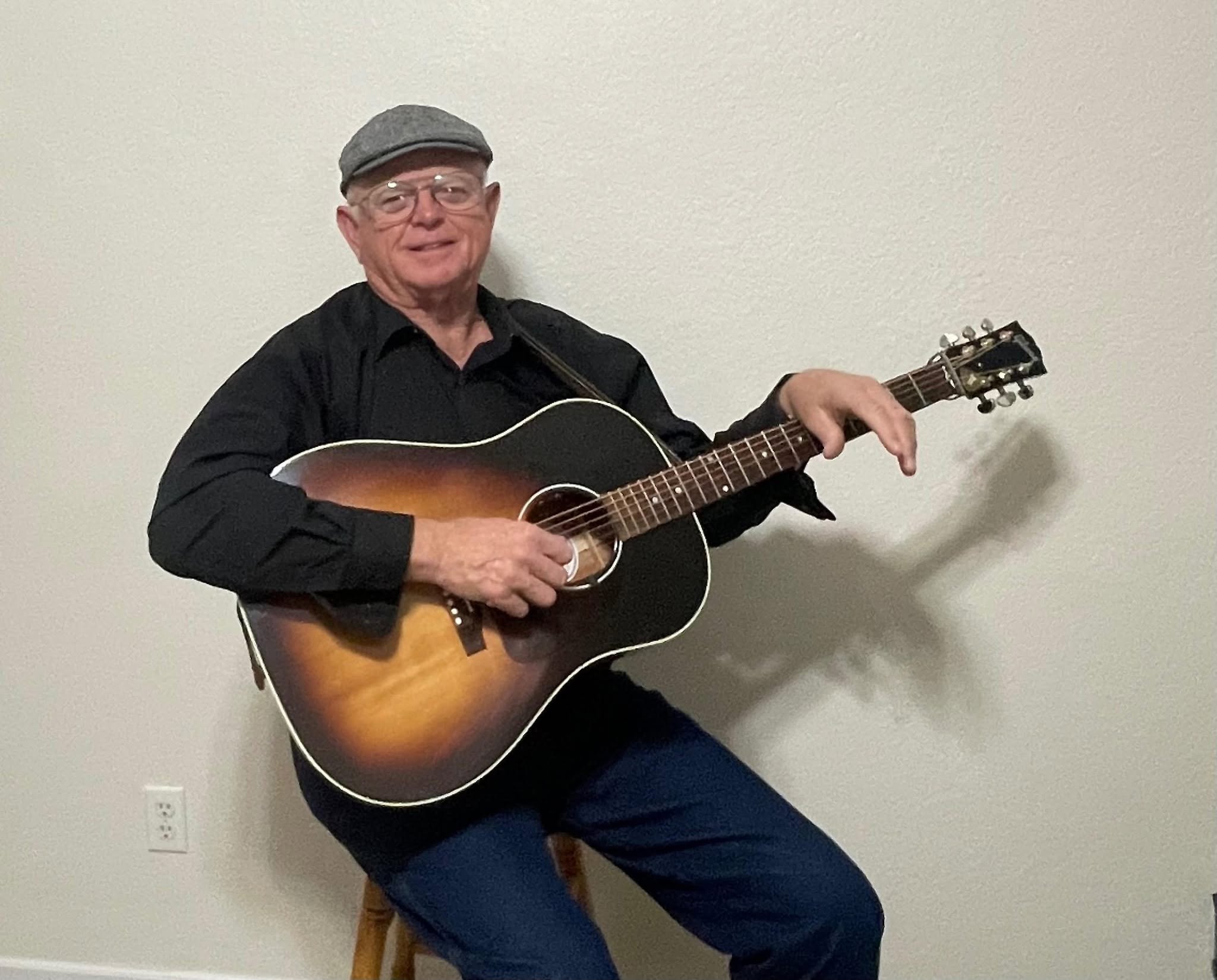 Jim Hayes playing acoustic guitar